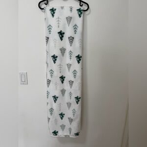 White fleece throw blanket with green and gray Christmas tree pattern
